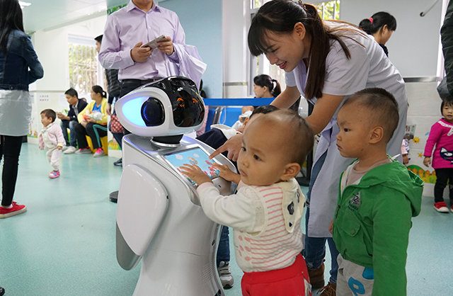 现场儿童争相与三宝平台机器人互动